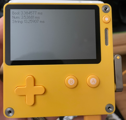 The image shows a yellow handheld gaming device, the Playdate, with performance benchmark results displayed on its screen. The screen displays the following text:
Bool: 3.384577 ms
Num: 3.53881 ms
String: 13.25907 ms